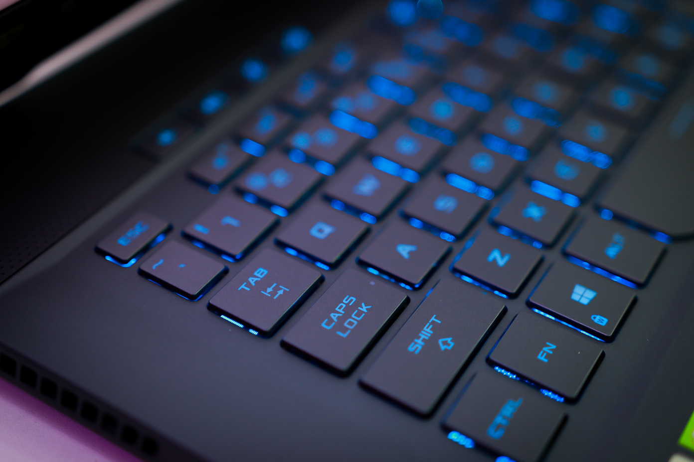 Black Computer Keyboard with Blue Light in Close Up Photography